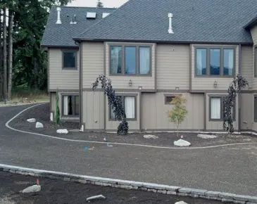 A large house with a circular driveway in front of it.