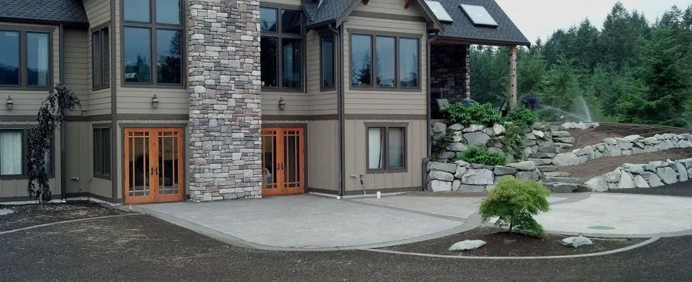 A large house with a lot of windows and a stone chimney