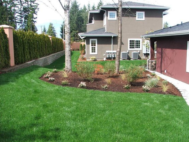 A house with a lush green lawn in front of it