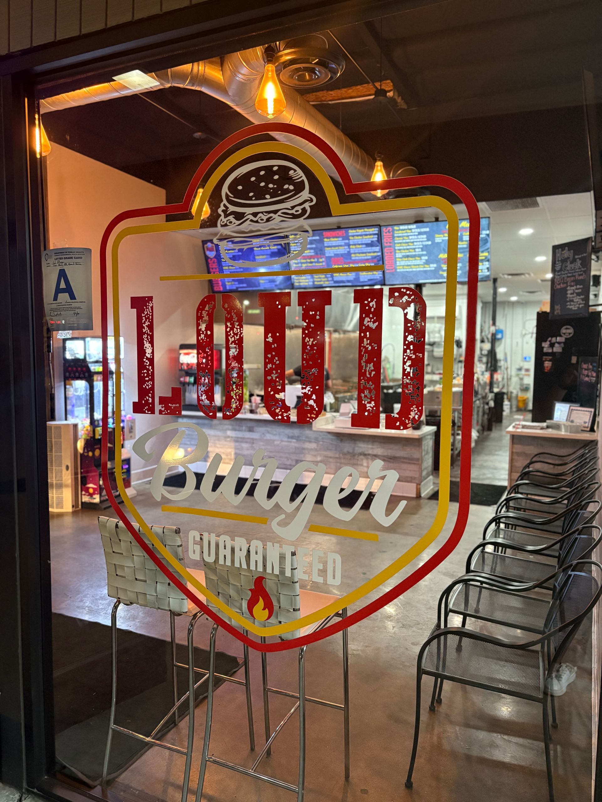 Restaurant entrance with Loud Burger logo.