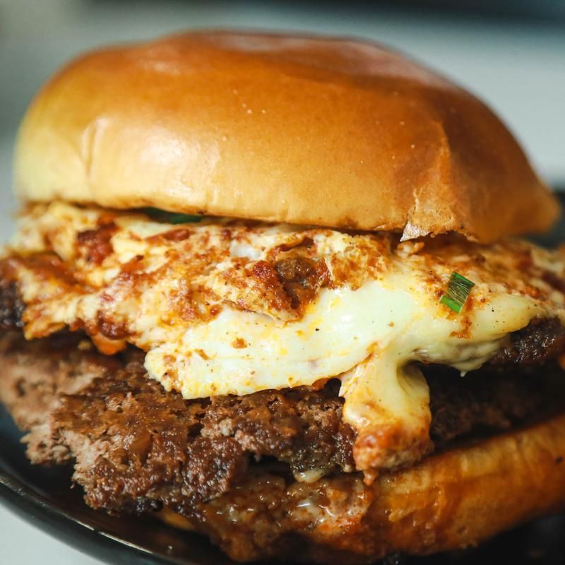 Burger with fried egg on a bun.