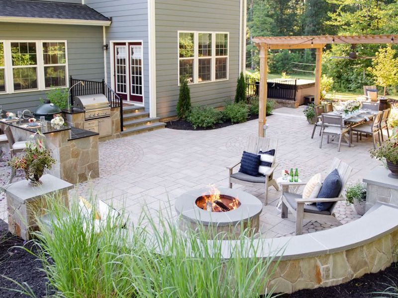 There is a fire pit in the middle of the patio.