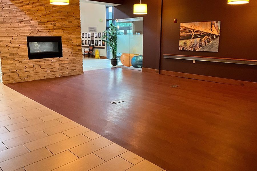 A large room with a fireplace and a picture on the wall