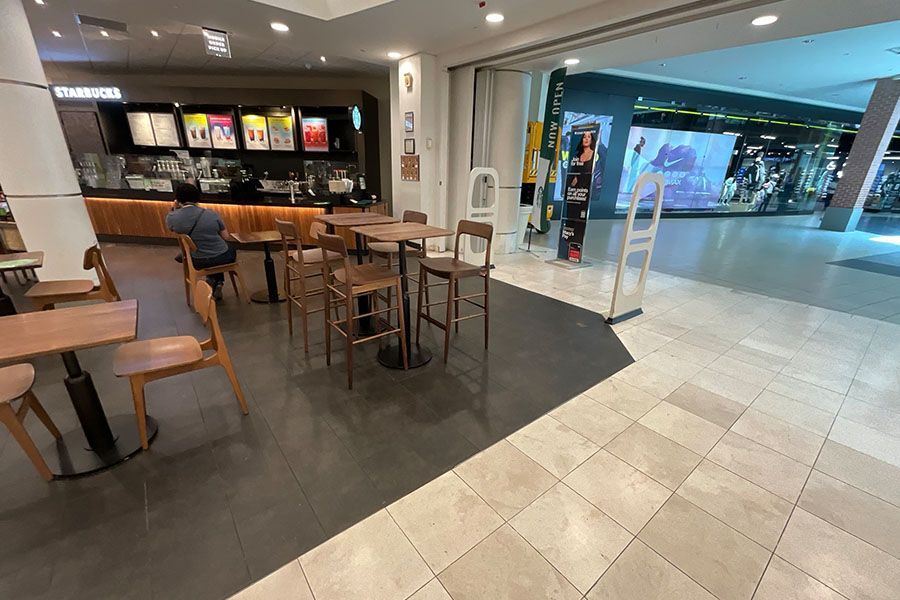 A man is sitting at a table in a restaurant.