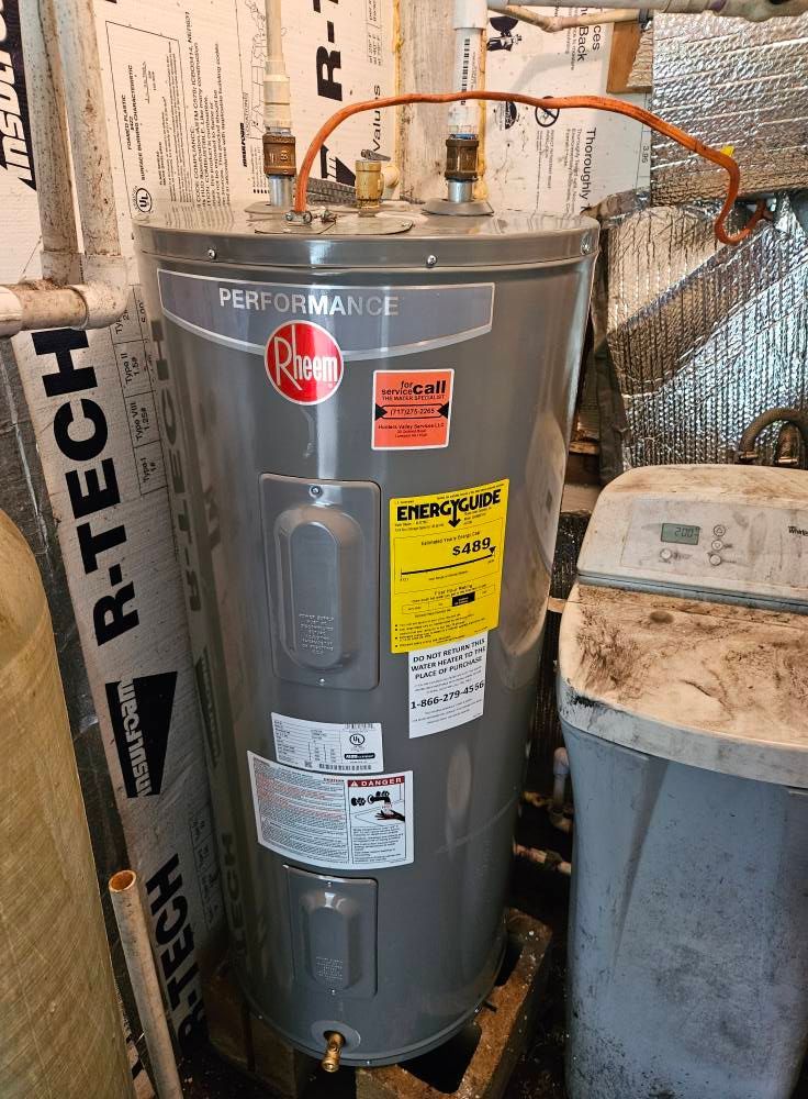 Gray Rheem Performance water heater with yellow energy guide label.