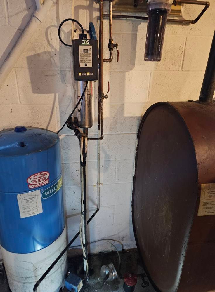 Oil tank, water tank, and water filtration system in a basement.