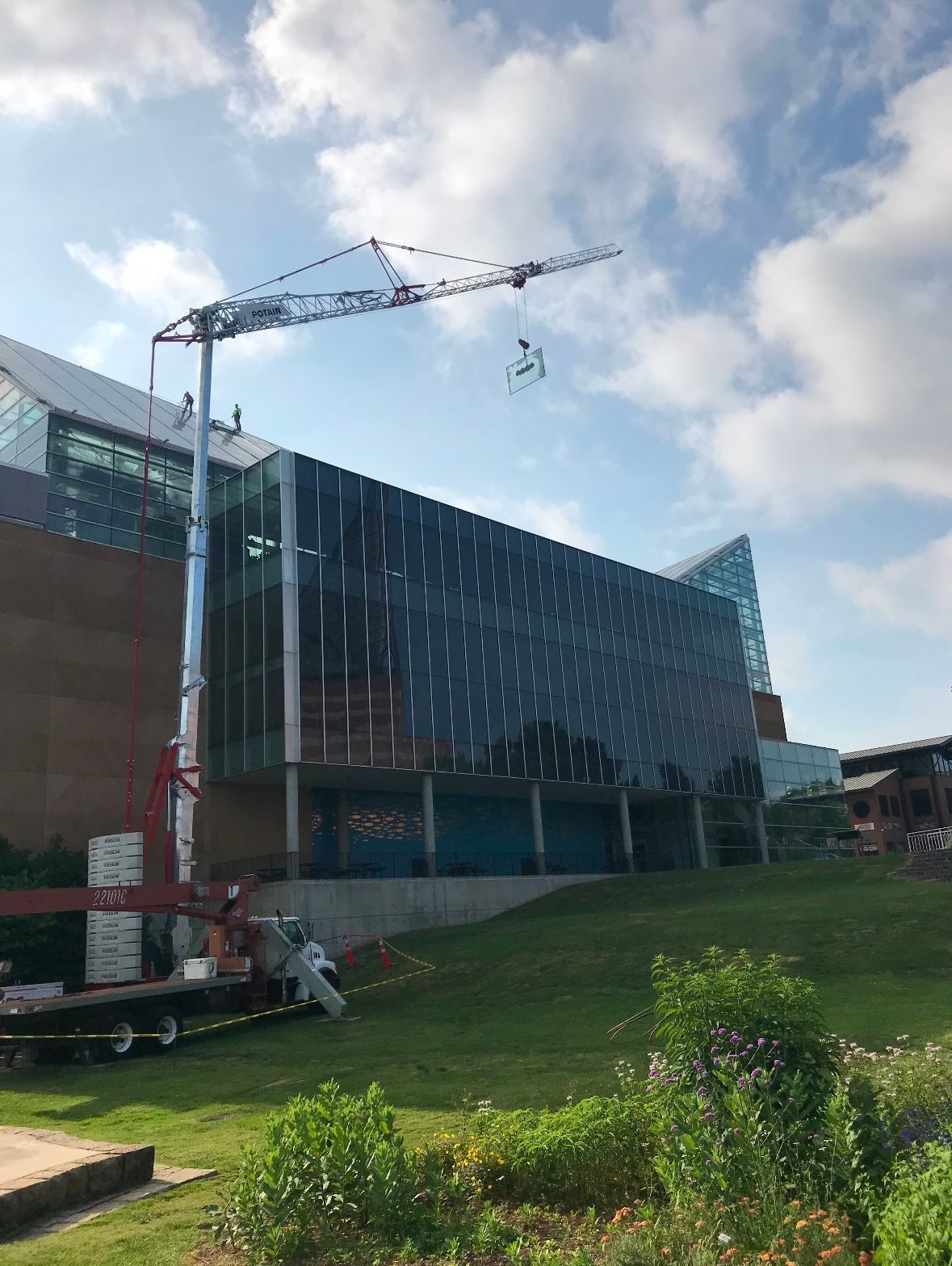 A large building under construction with a crane in front of it.