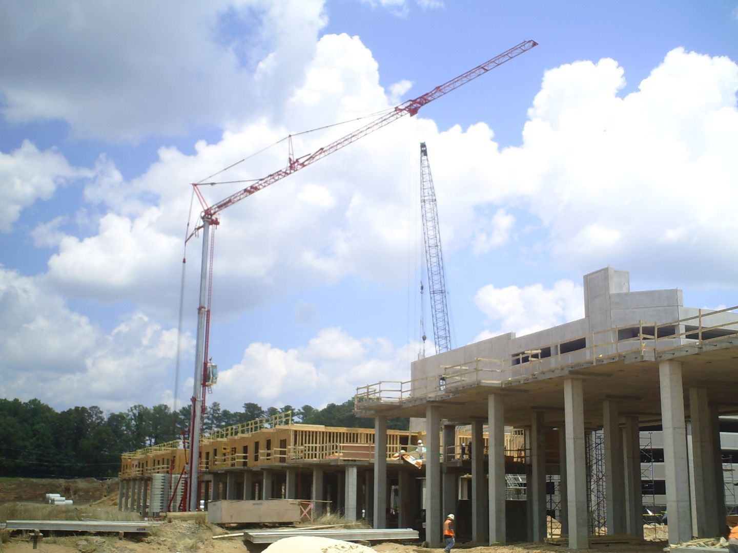 A large building under construction with a crane in the foreground