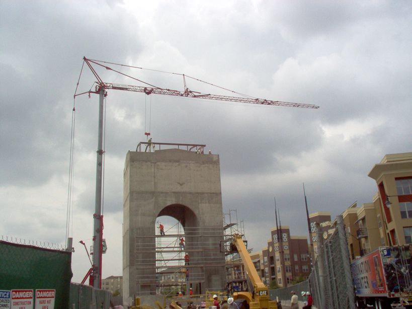 A construction site with a crane and a sign that says danger