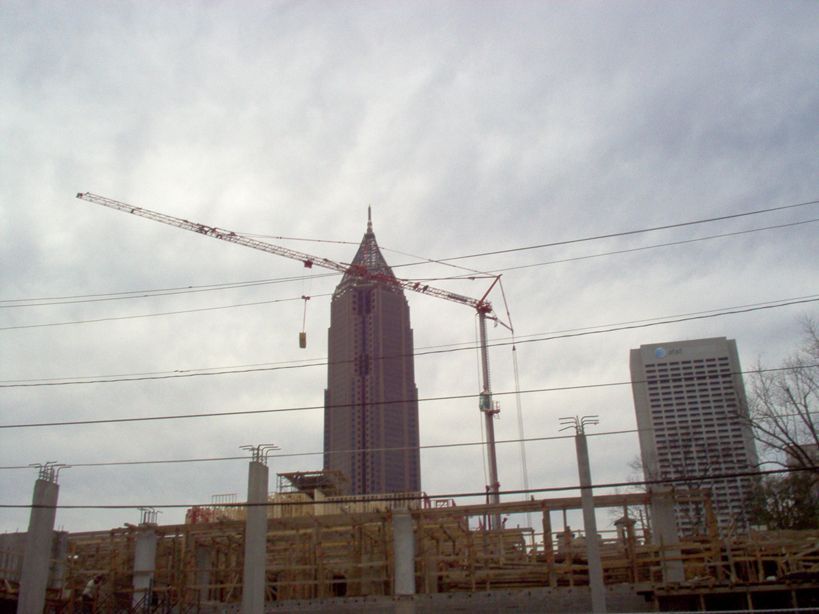 A construction site with a tall building in the background