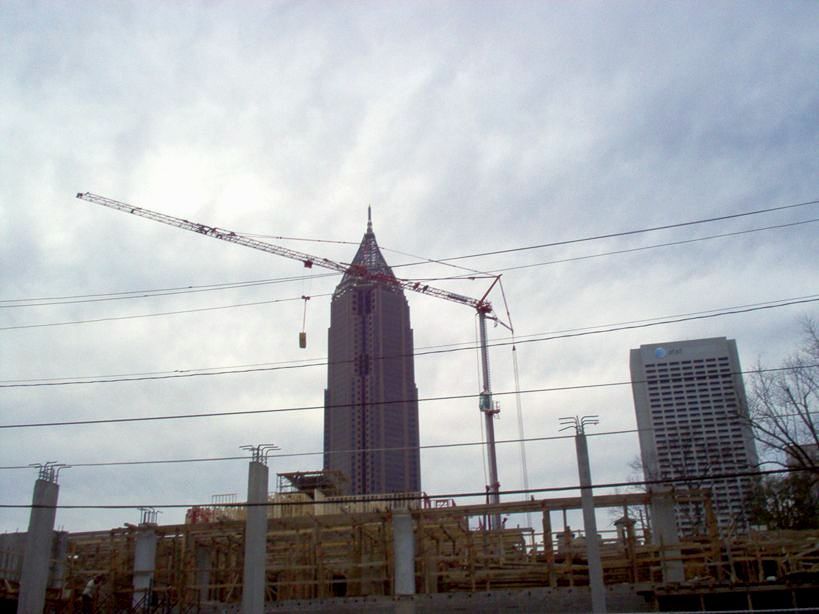 A construction site with a tall building in the background