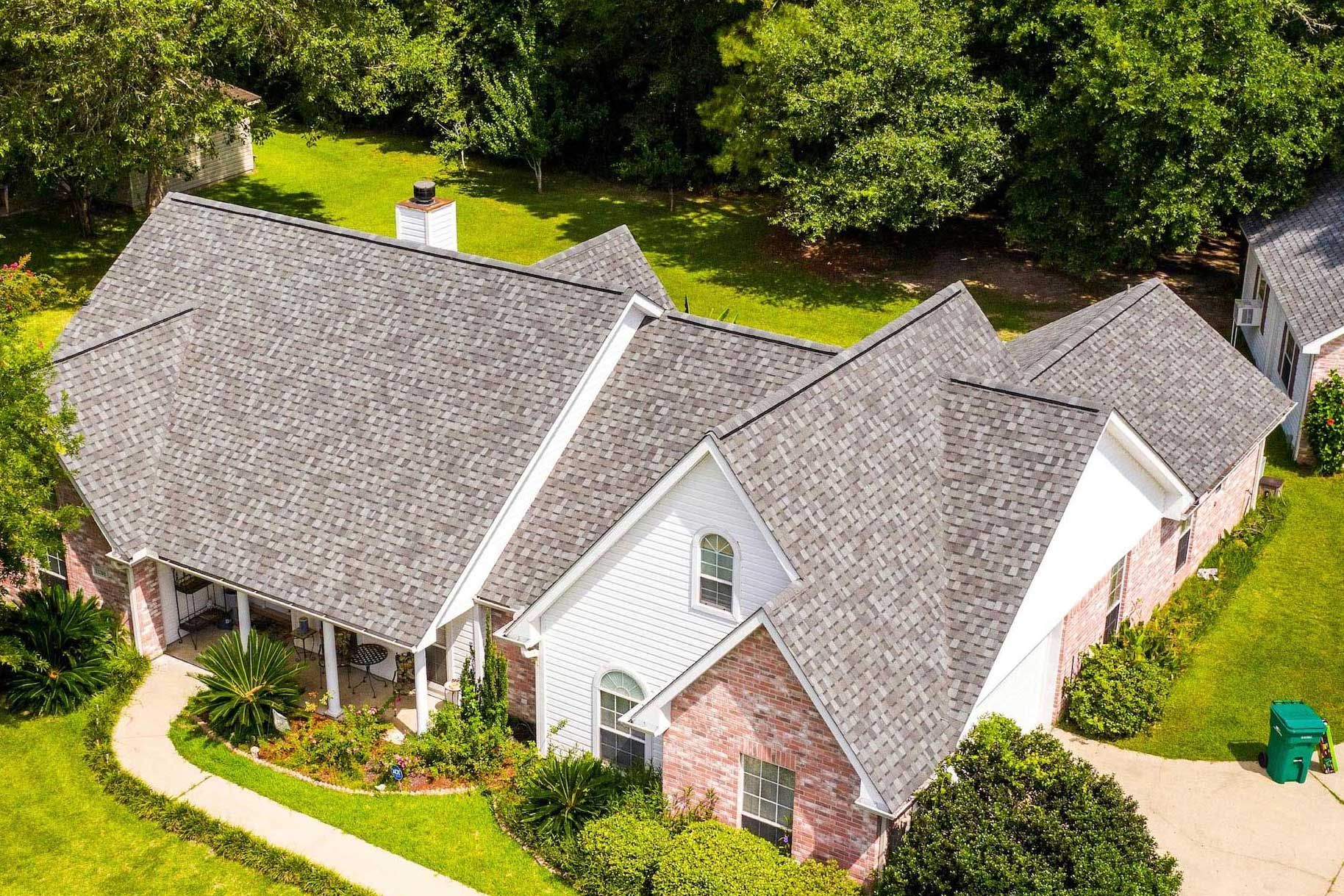 An aerial view of a house with a new roof.