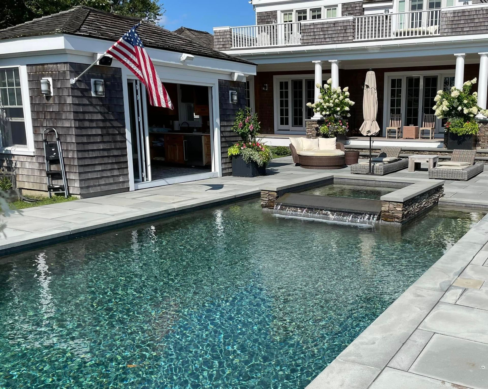 A large house with a swimming pool in front of it