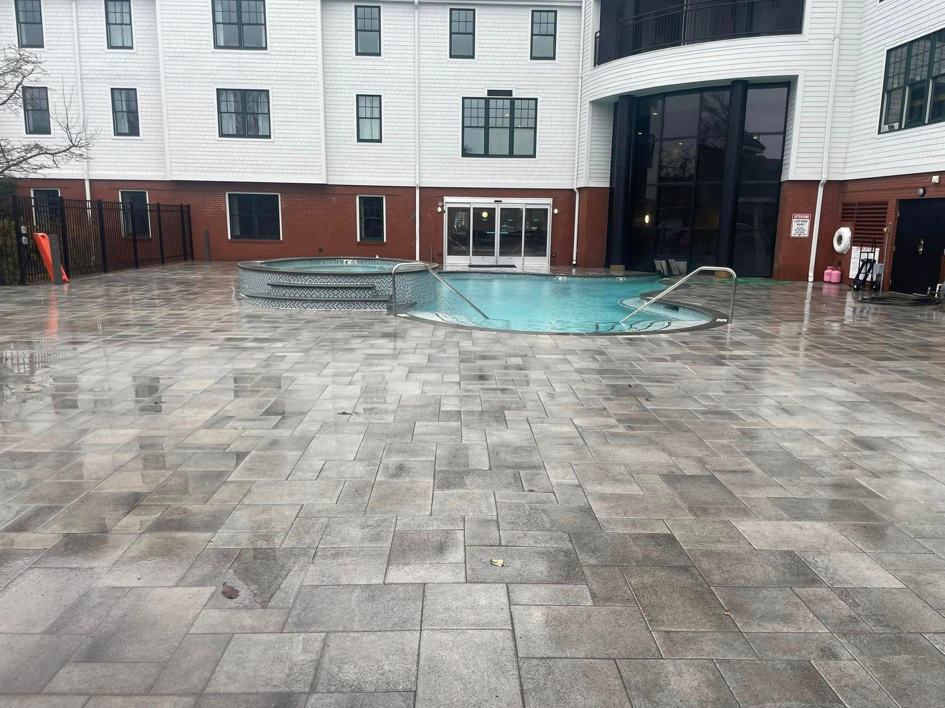 A large building with a swimming pool in front of it