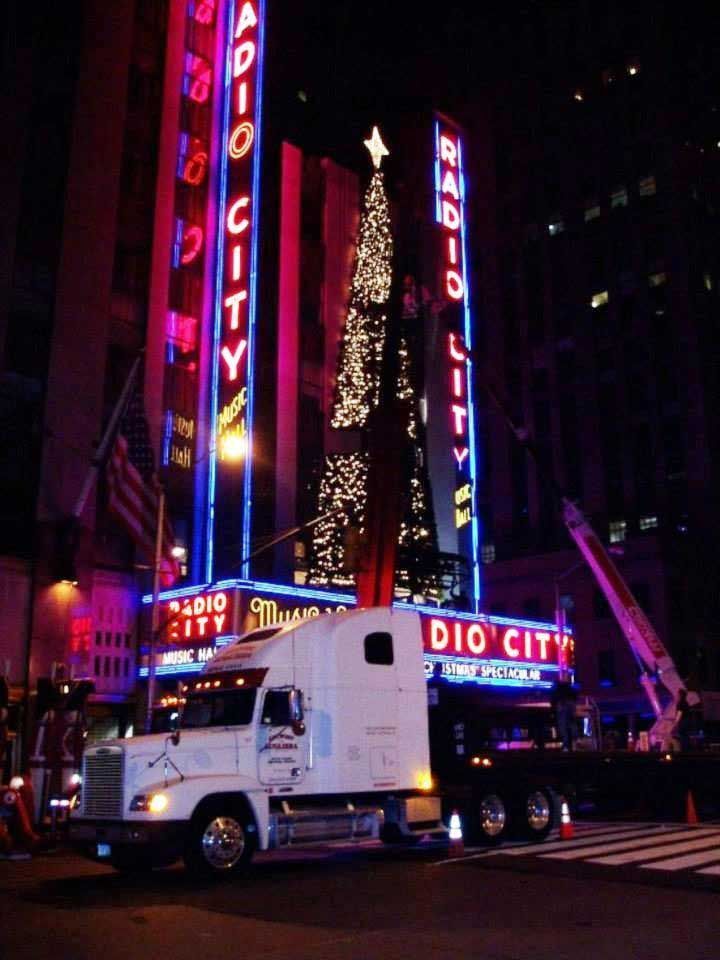 A truck is parked in front of a radio city building