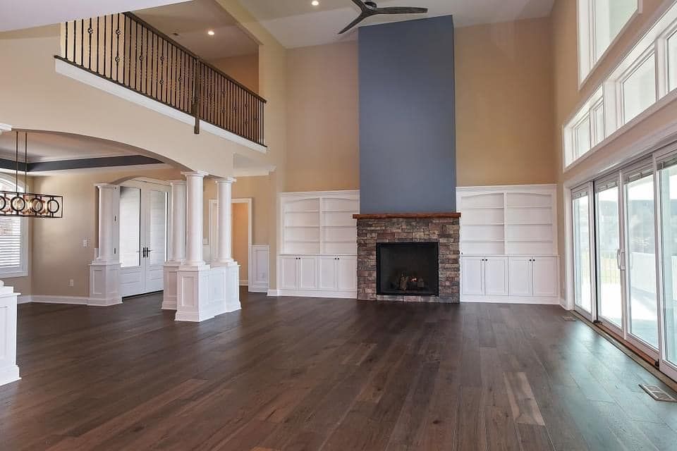 an empty room with a sliding barn door and a ceiling fan .