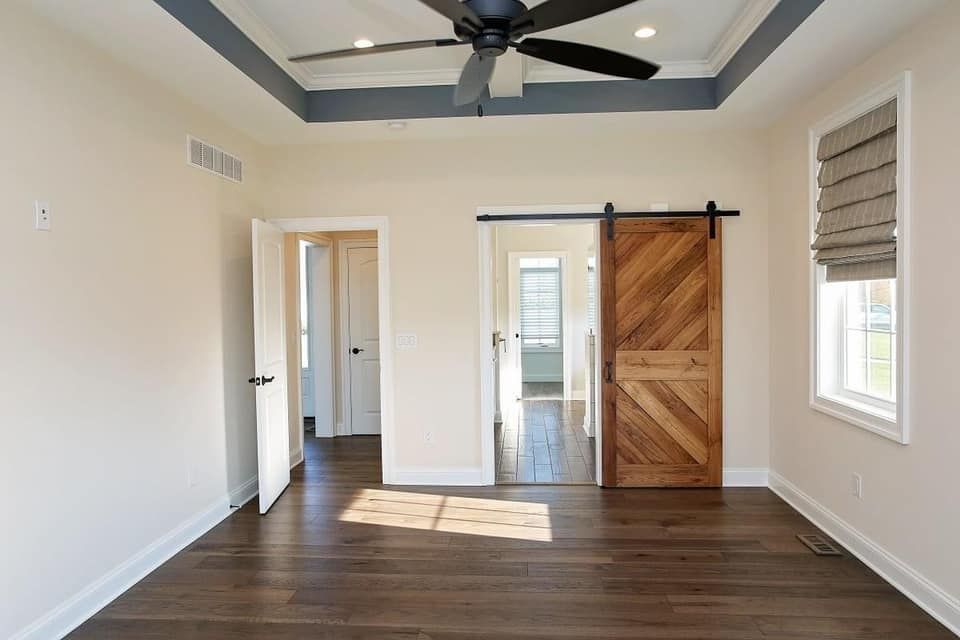 a white house with a blue roof and a white van parked in front of it .