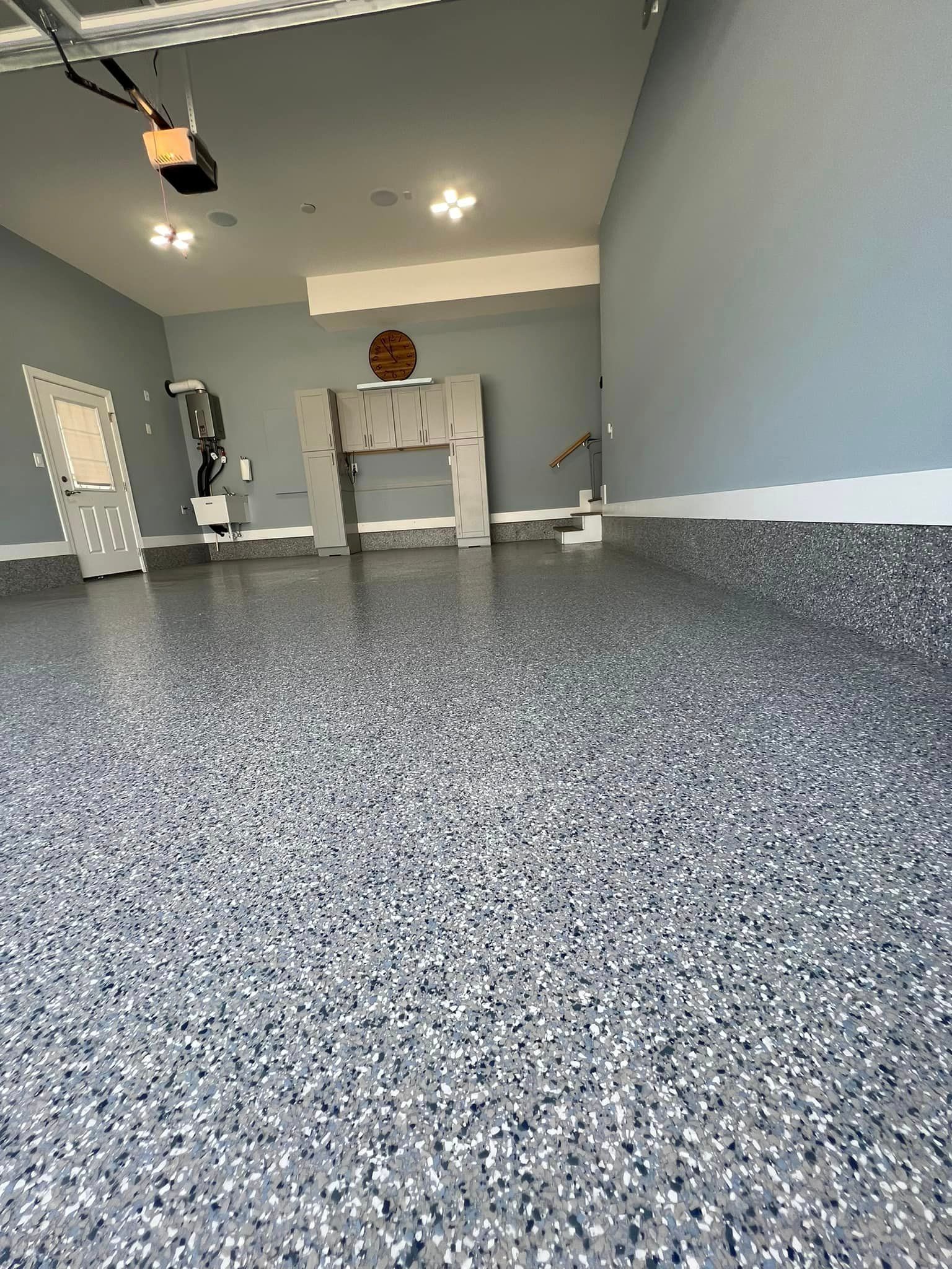a garage with a gray floor and blue walls .