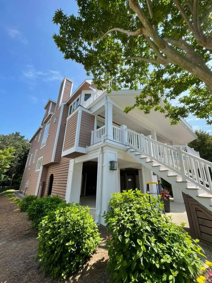 a warehouse with green doors and white walls has a lot of lights on the ceiling .