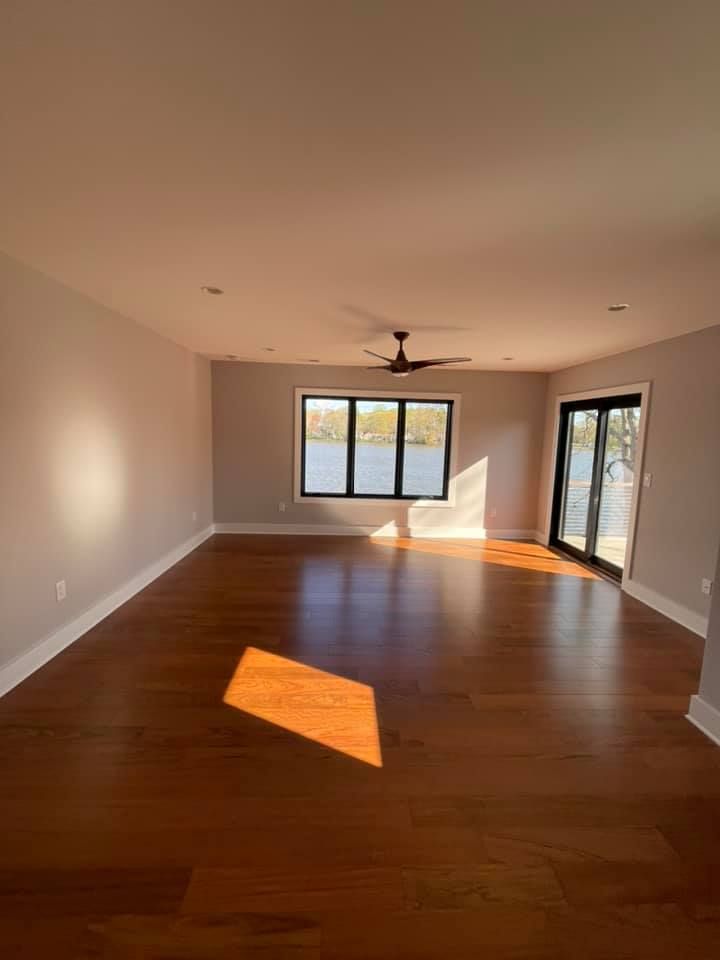 a car is parked in a garage under a porch .