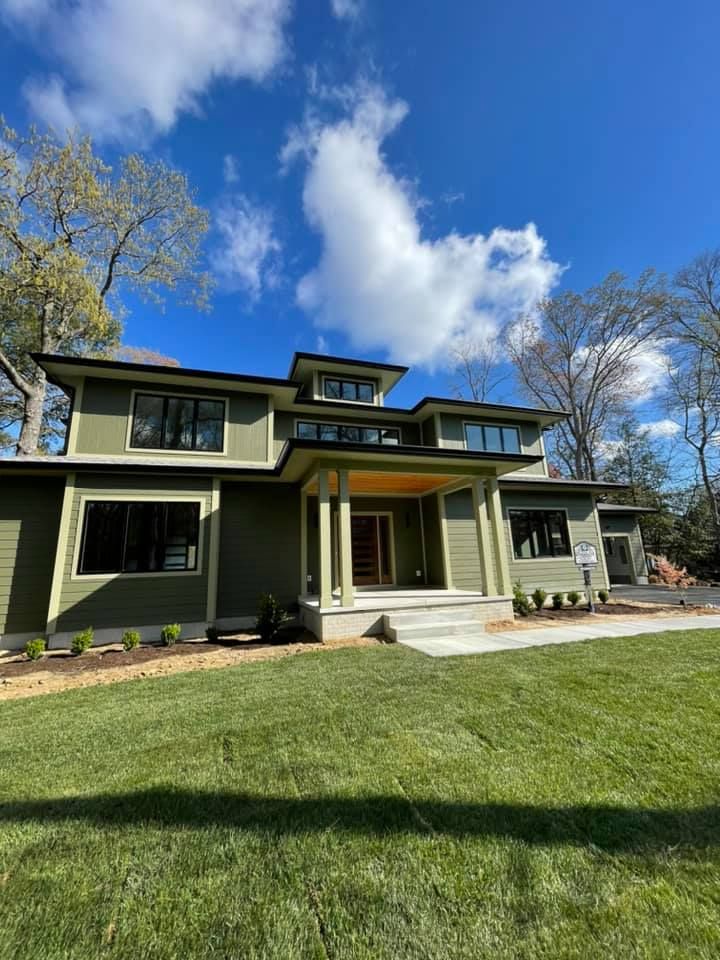 an empty living room with hardwood floors and a ceiling fan .