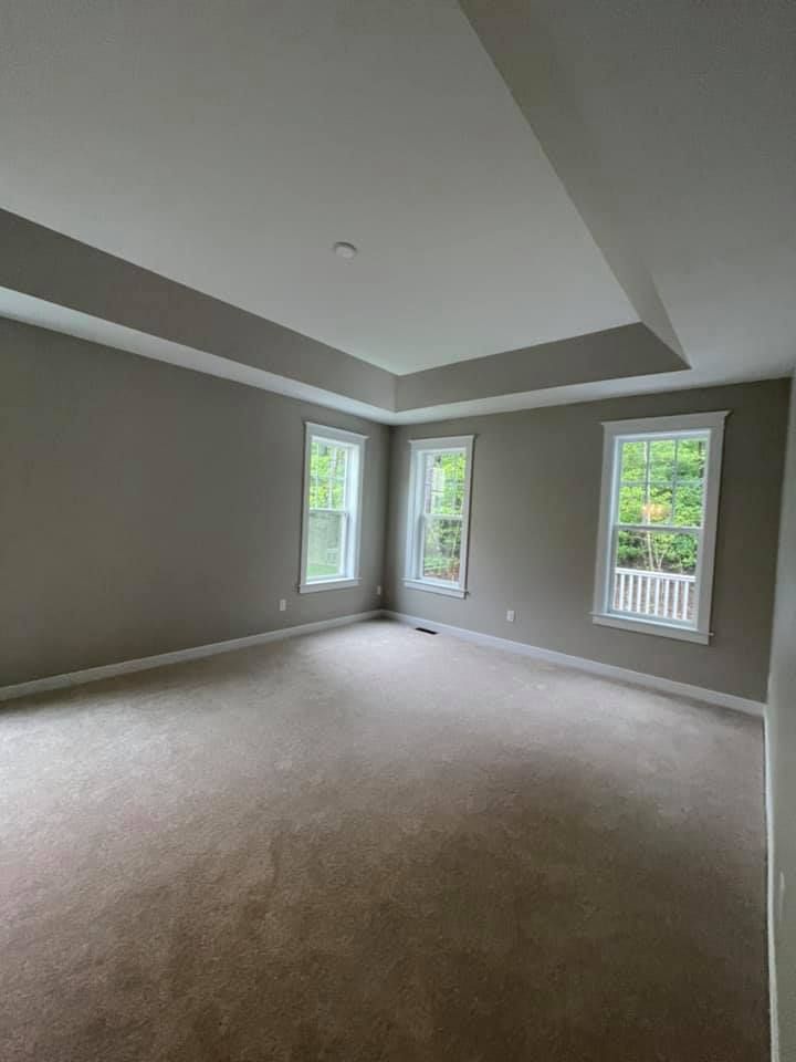 an empty hallway with hardwood floors and stairs in a house .