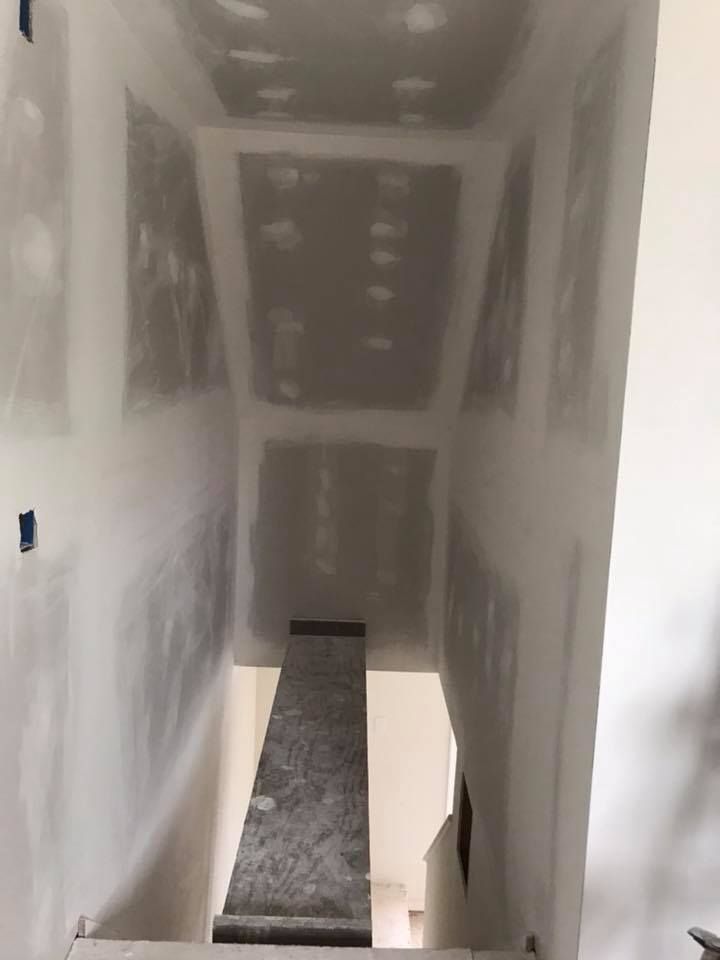 an empty room with blue walls and a ceiling fan .