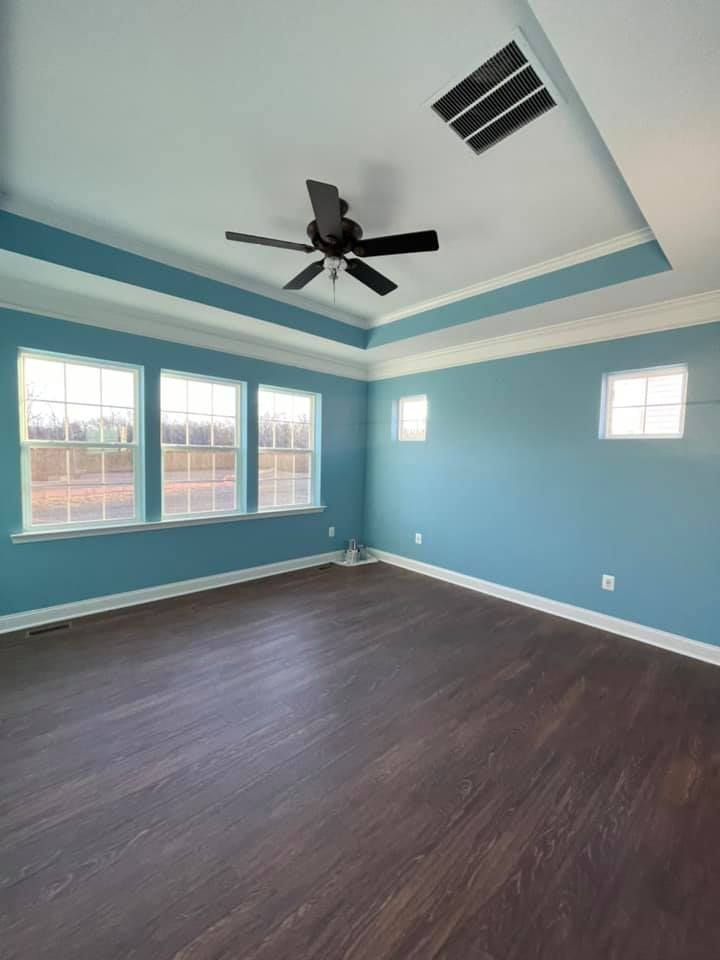 an empty living room with hardwood floors and a fireplace .