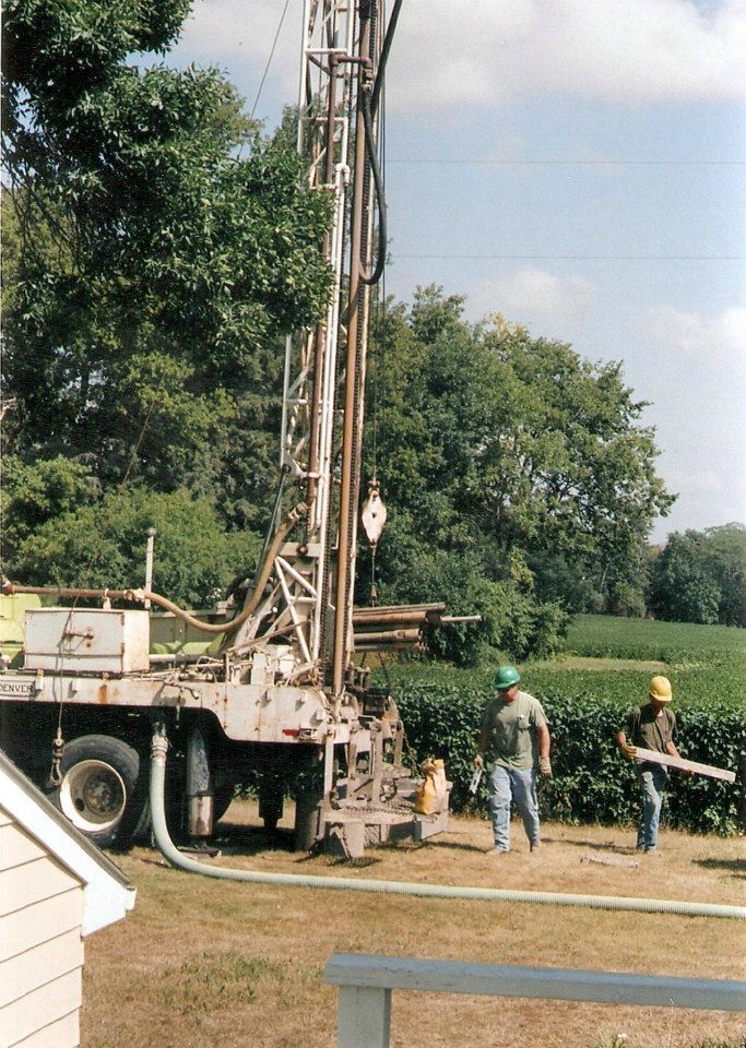 A group of men are working on a drilling rig
