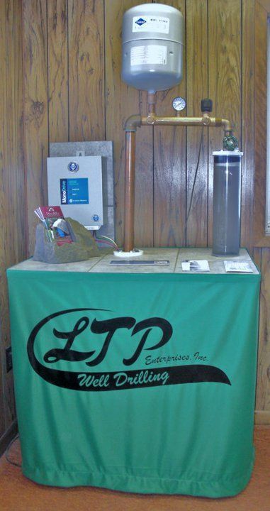 A green table cloth with the letters ltp on it
