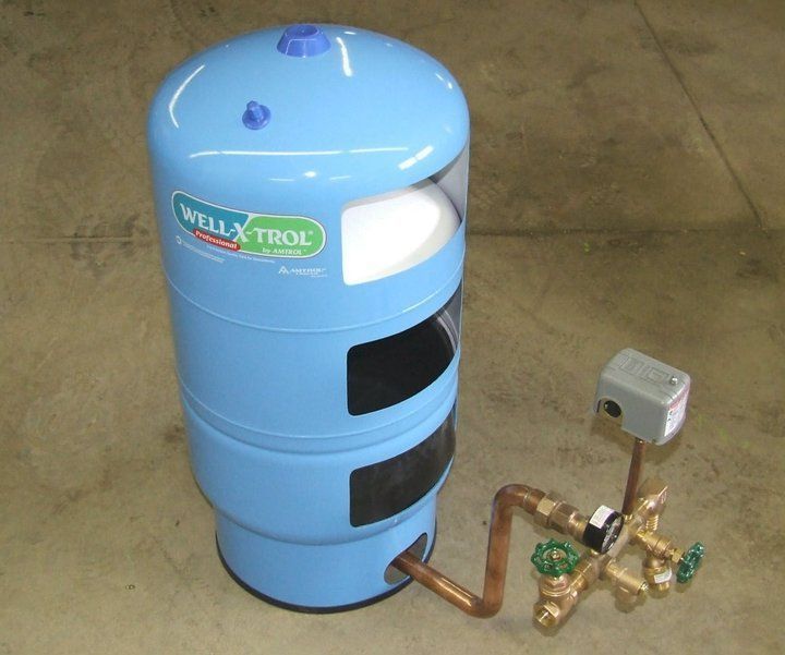 A blue well trol water tank with copper pipes attached to it
