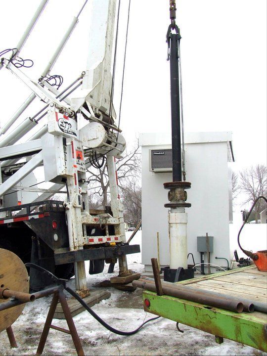A crane is attached to the back of a truck