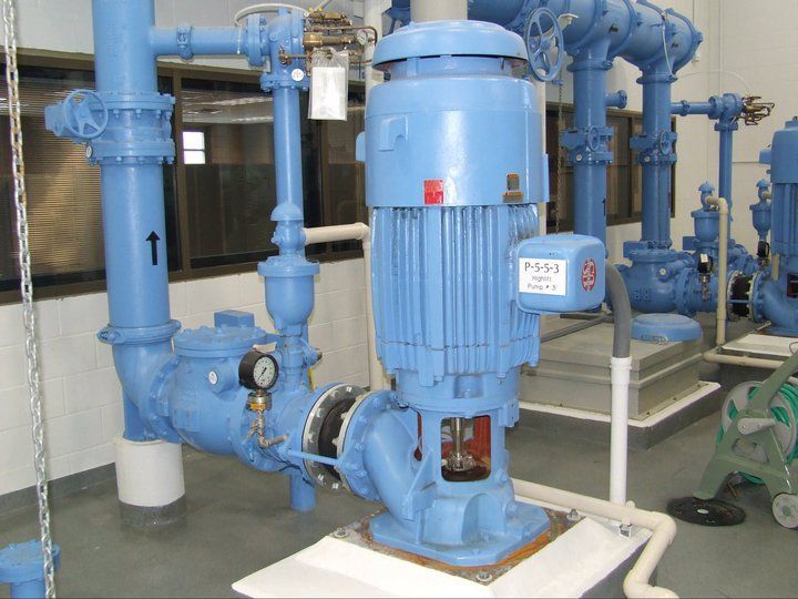 A room filled with lots of blue pipes and pumps