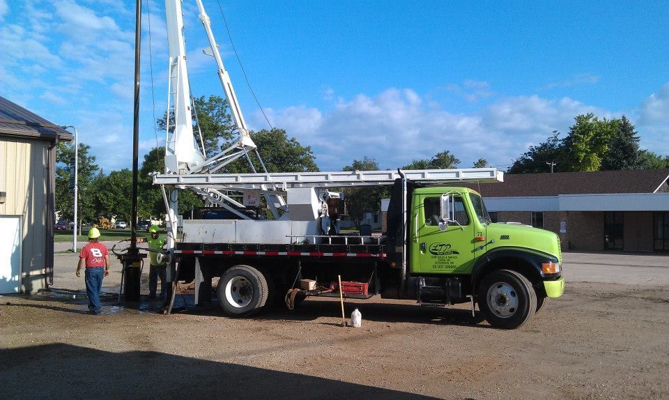 A green truck with the word age on the side