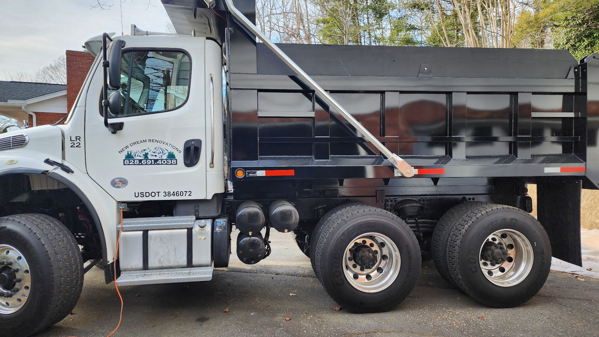 A dump truck is parked on the side of the road.