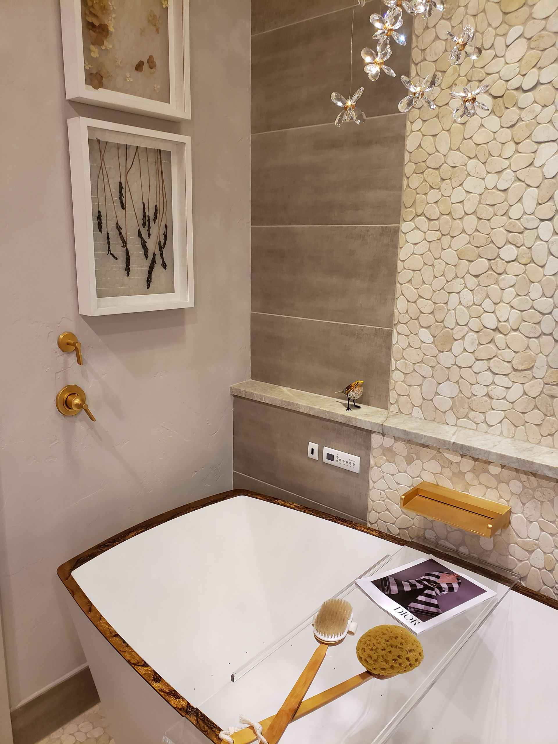 A bathroom with a bathtub and a picture on the wall