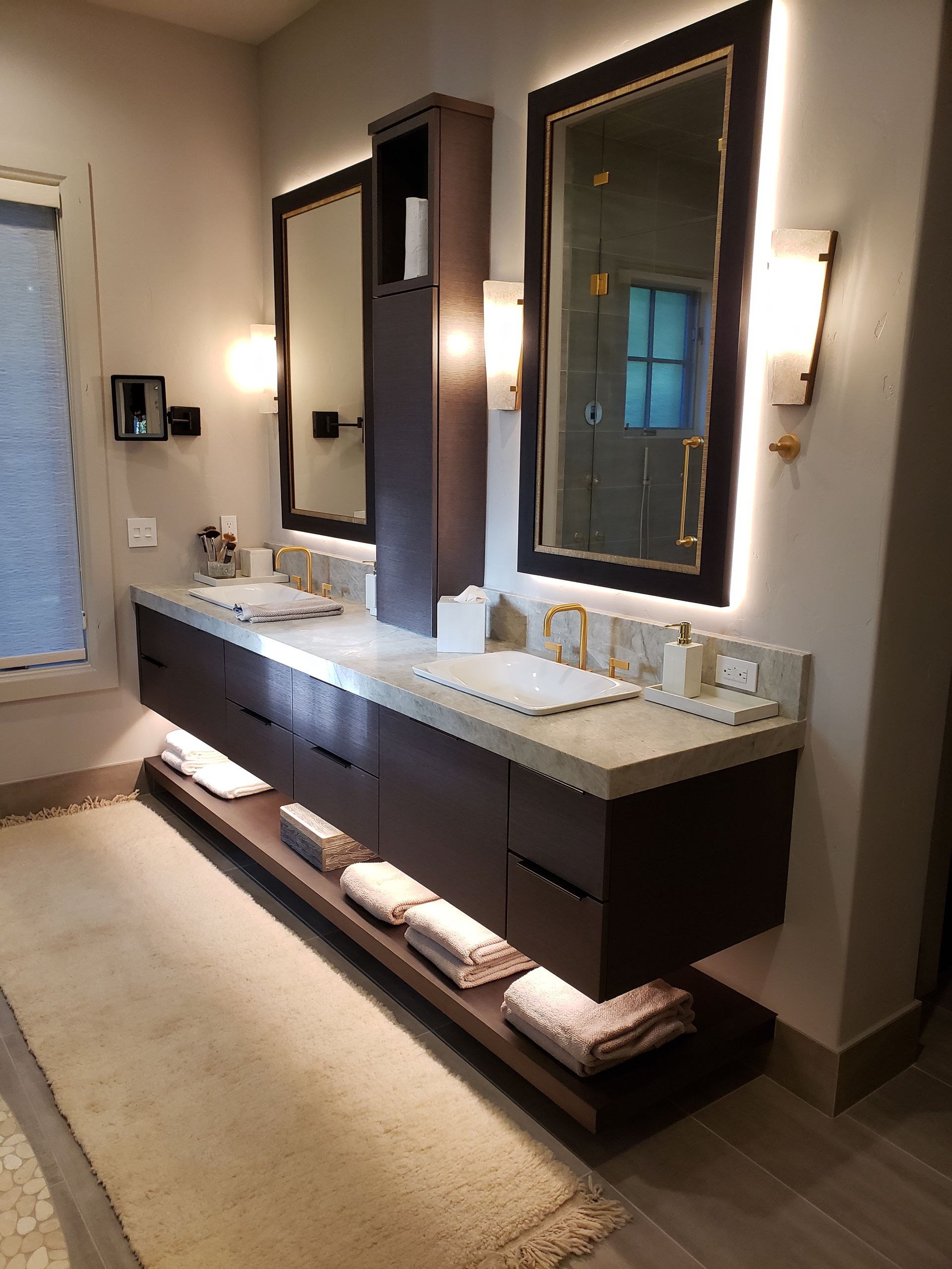 A bathroom with two sinks and two mirrors