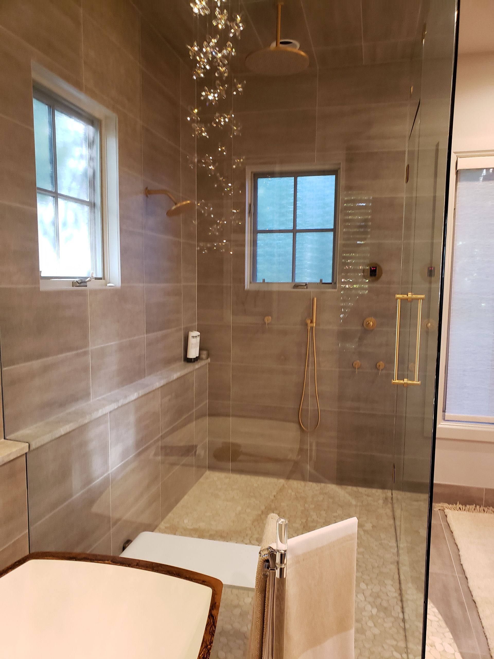 A bathroom with a walk-in shower and a window