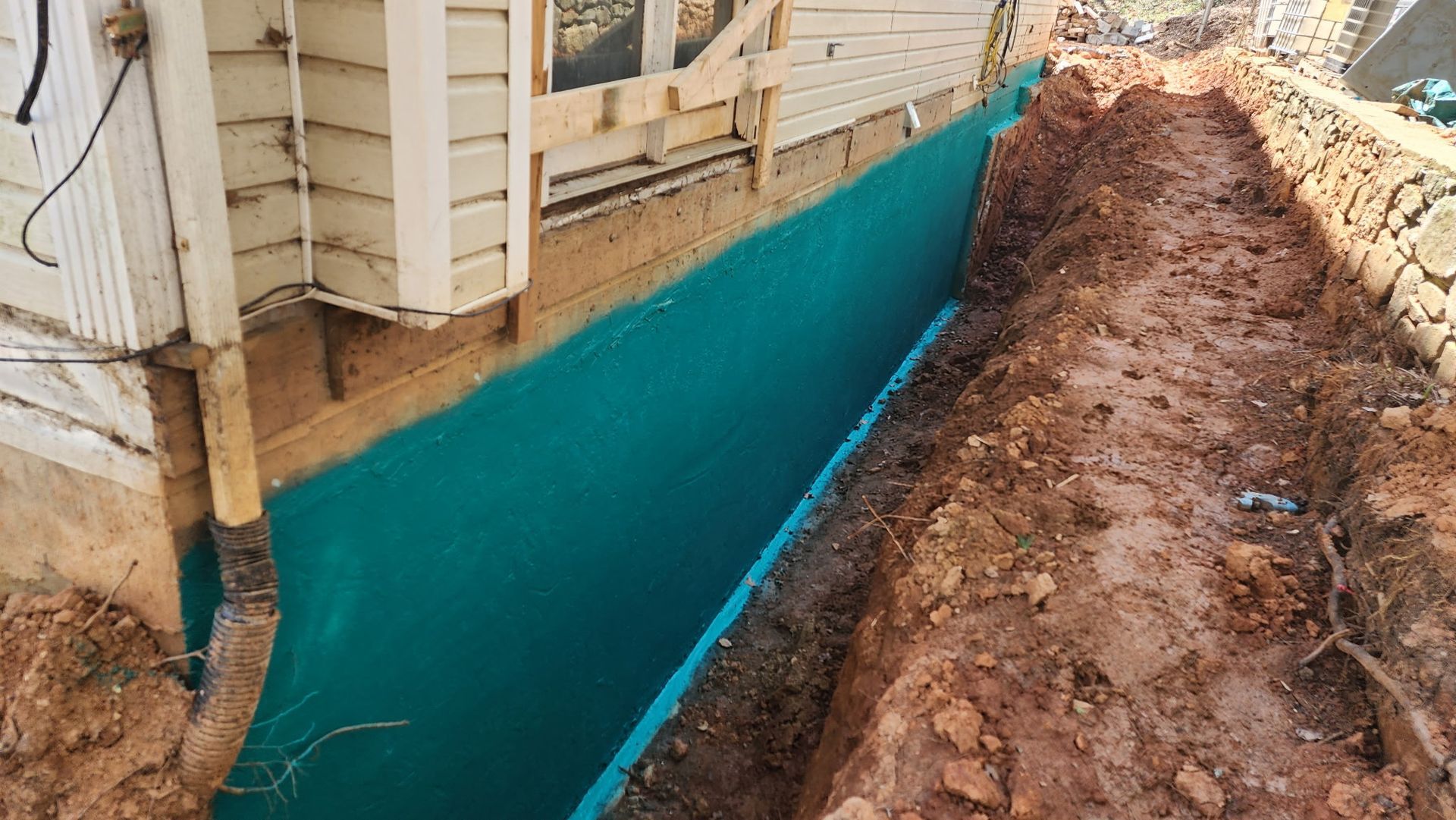 The house is currently undergoing waterproofing treatment for its foundation.
