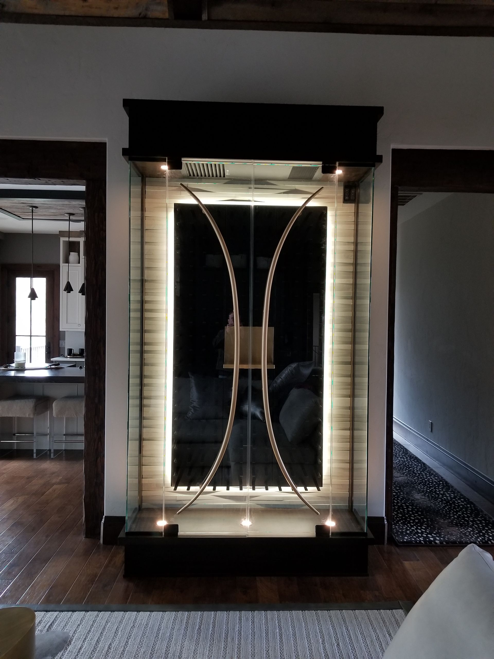 A living room with a large glass display case