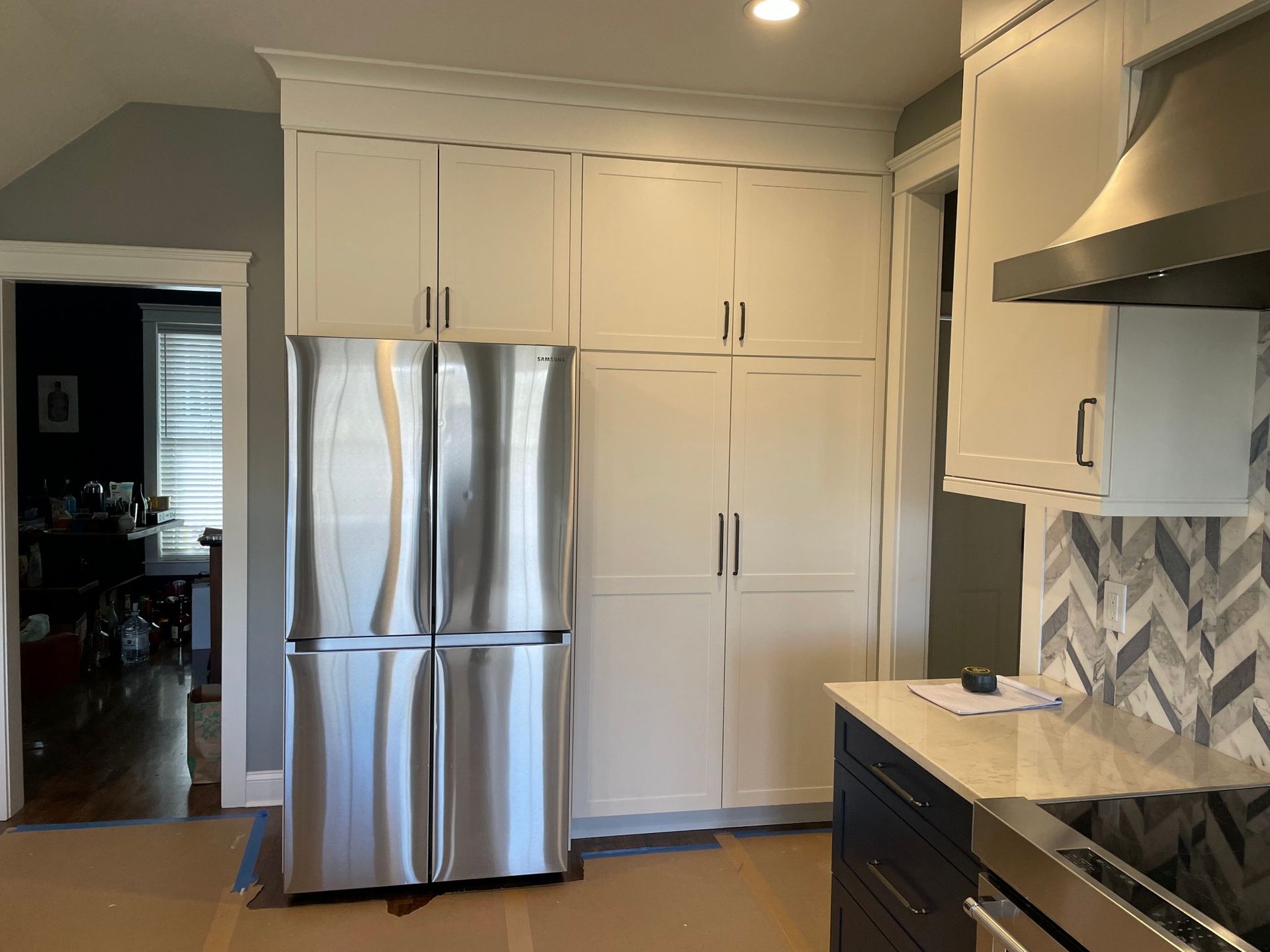 A kitchen with stainless steel appliances and white cabinets