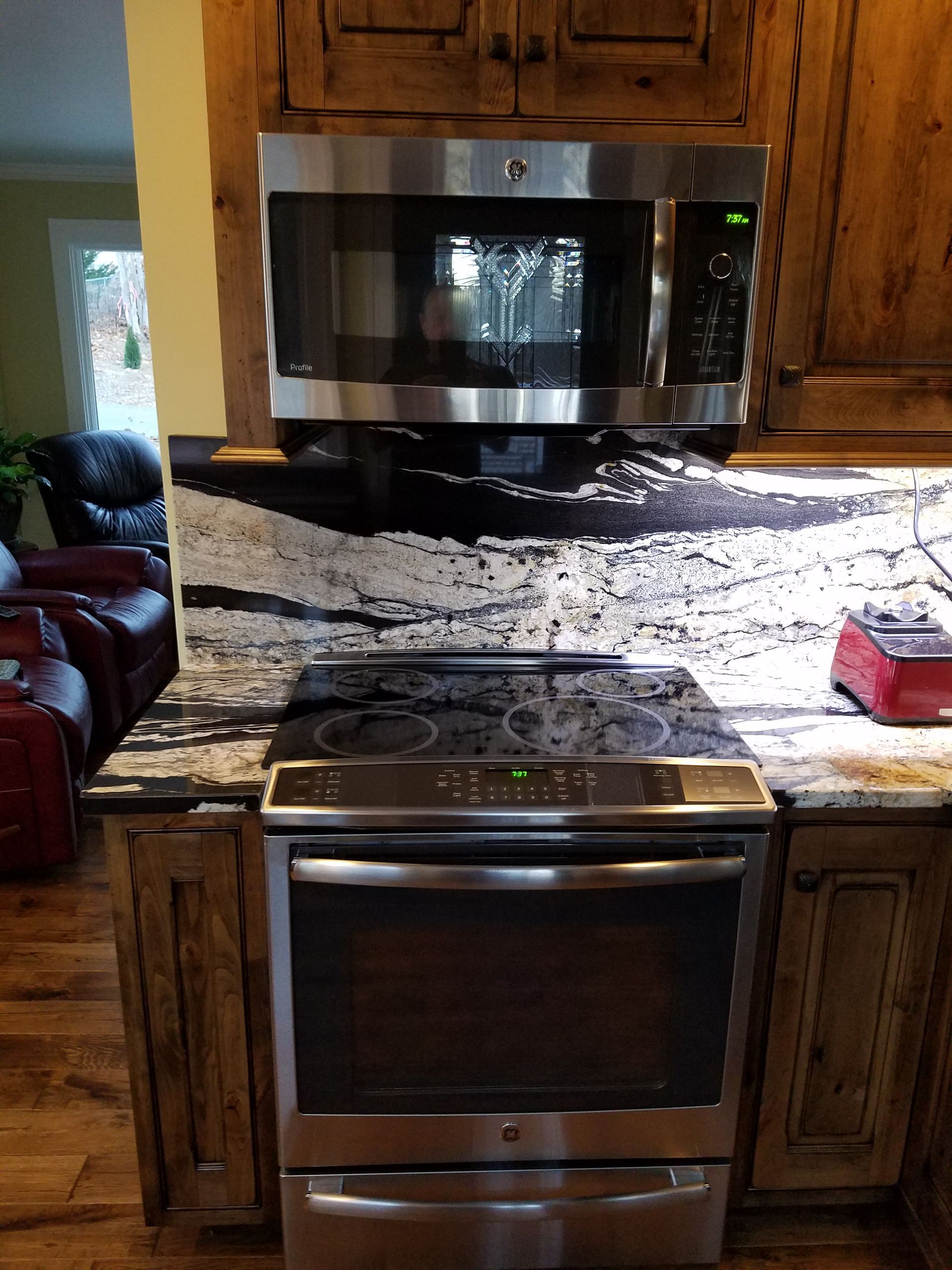 A kitchen with a stove top oven and a microwave