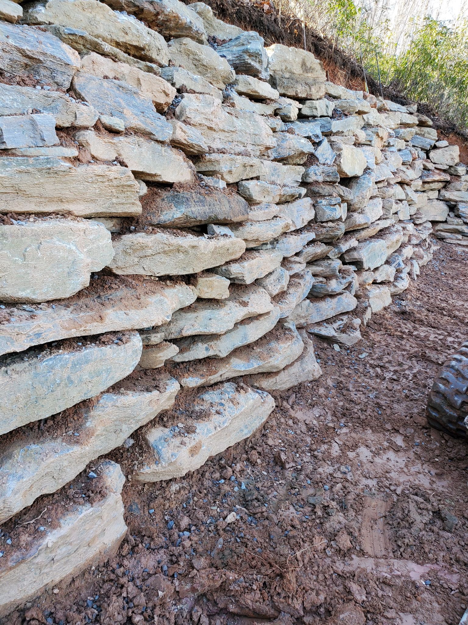 A pile of rocks stacked on top of each other on a dirt hill