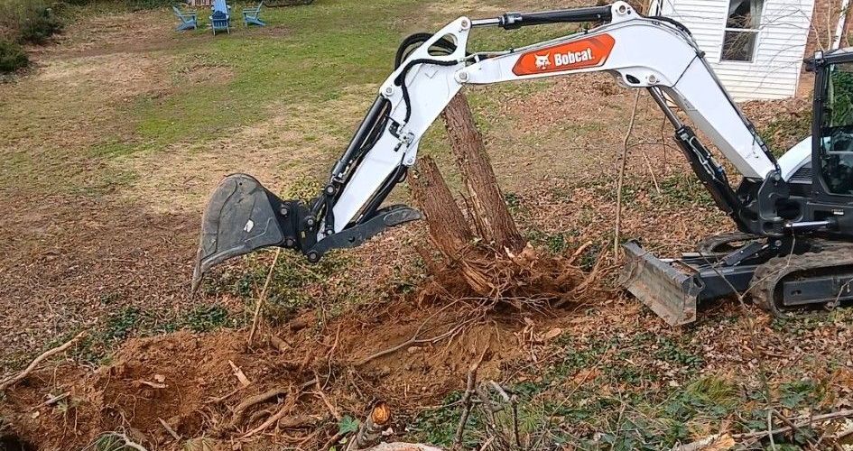 A small excavator is digging a hole in the ground