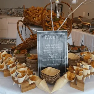 Buffet dessert display with assorted pastries, fruit tarts, and a menu card on a banquet table