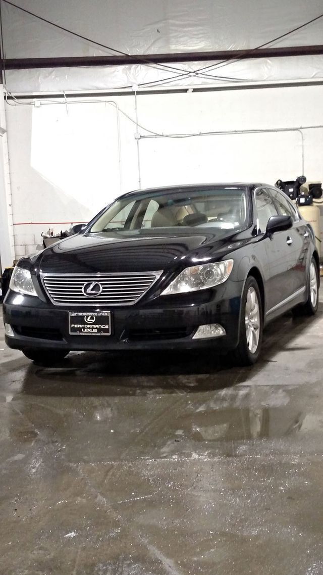 Black Lexus sedan in a garage.