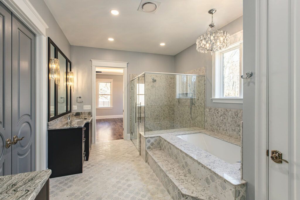 A large bathroom with a bathtub and a walk in shower.