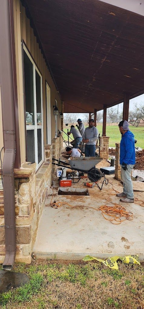 A group of people are working on a porch of a house.