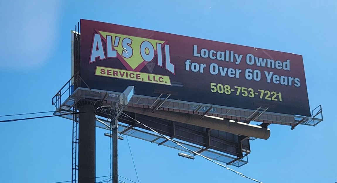 A billboard that says ' Al's Oil Service, LLC. Locally owned for over 60 years ' on it