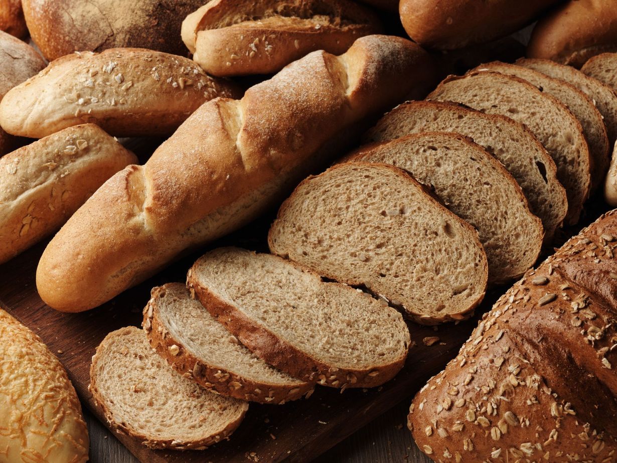 A bunch of different types of bread are on a table